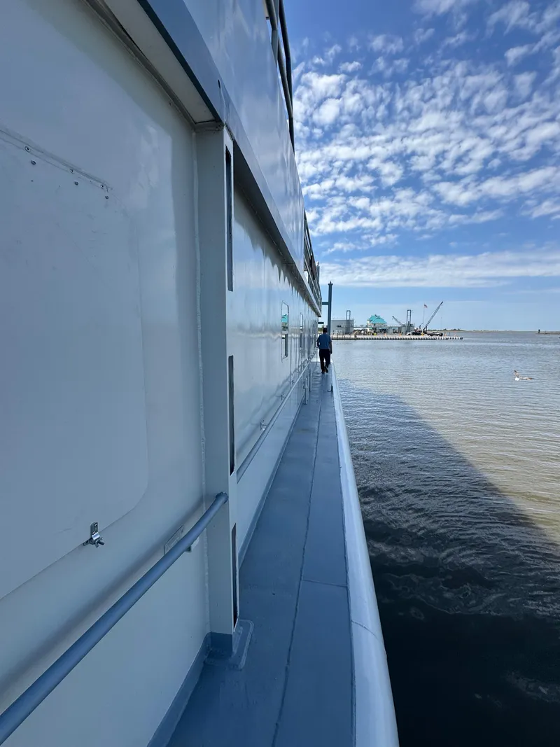 Slide: The Image of Side view of a 1985 custom houseboat on a calm, sunny day. - 41