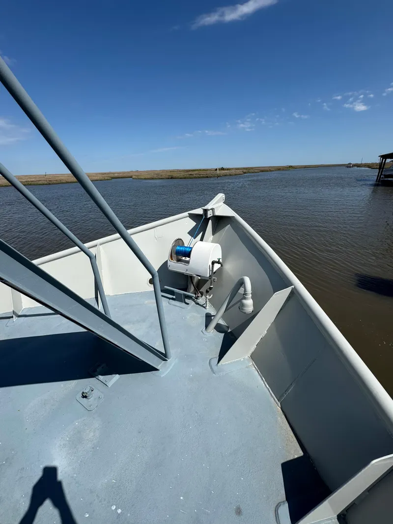 Slide: The Image of 1985 Custom House Boat deck with railing, overlooking calm waters under a clear blue sky. - 43