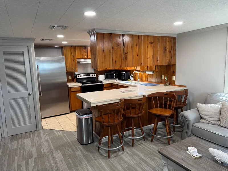 Slide: The Image of Cozy kitchen in 1985 custom houseboat with wooden cabinets and modern appliances. - 49