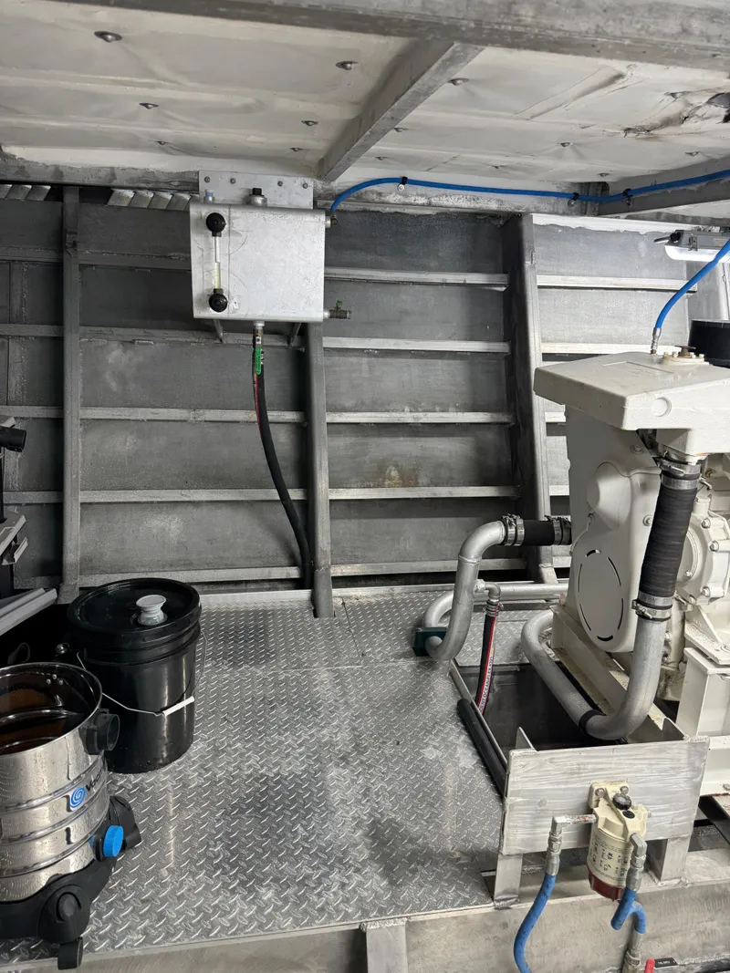 Slide: The Image of Engine room of a 1985 custom houseboat with mechanical equipment and piping. - 8