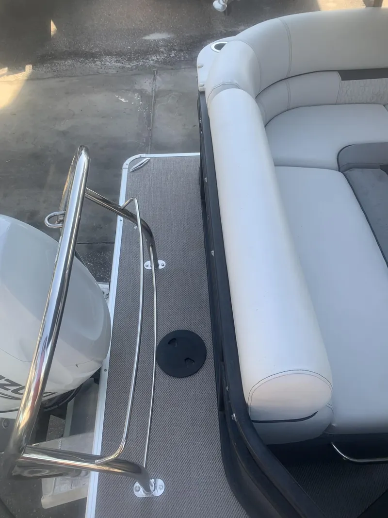 Slide: The Image of 2021 Godfrey Sweetwater 2086 BF boat with cushioned seating and railing, viewed from above. - 11