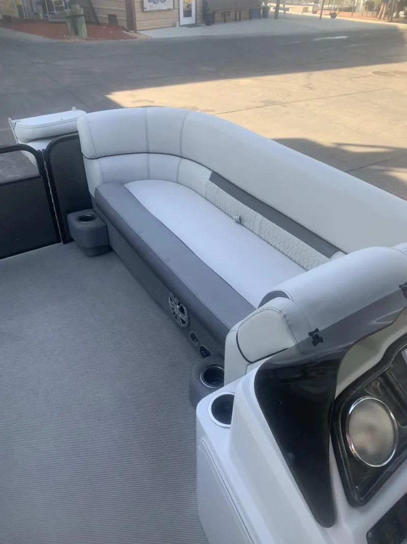 Slide: The Image of 2021 Godfrey Sweetwater 2086 BF boat interior with white seating and steering console. - 5