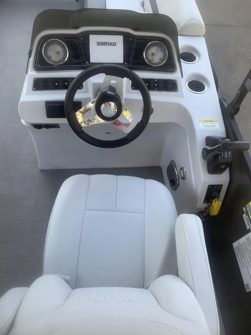 Slide: The Image of 2021 Godfrey Sweetwater 2086 BF boat dashboard with steering wheel and controls. - 8