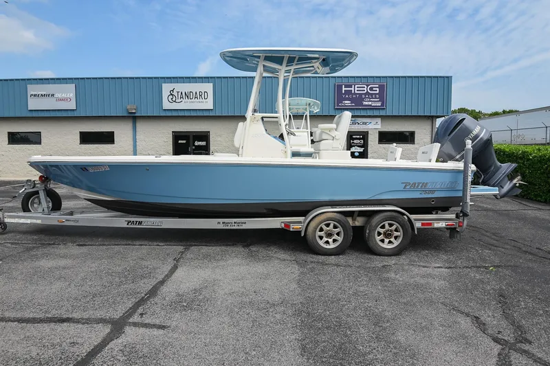Slide: The Image of 2021 Pathfinder 2500 Hybrid boat on a calm lake with scenic background. - 0