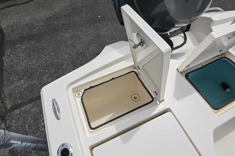 Slide: The Image of 2021 Pathfinder 2500 Hybrid boat storage compartments with open lids, showcasing interior space. - 12