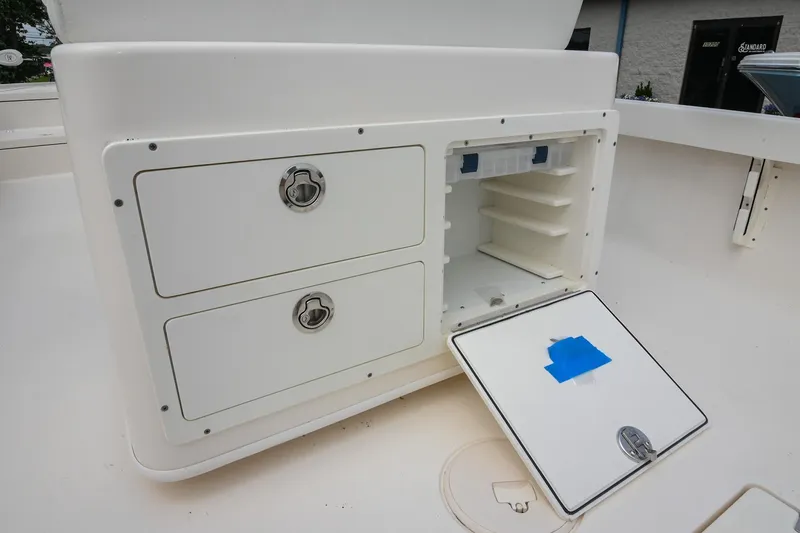 Slide: The Image of 2021 Pathfinder 2500 Hybrid boat storage compartments under blue canopy. - 17