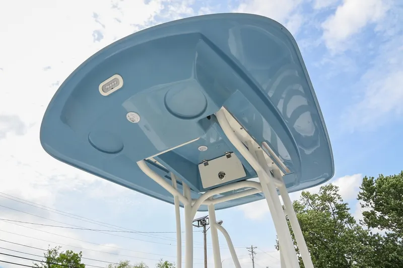 Slide: The Image of 2021 Pathfinder 2500 Hybrid boat with steering console, parked in a lot with vehicles. - 18