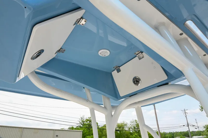 Slide: The Image of 2021 Pathfinder 2500 Hybrid boat console with steering wheel and navigation system in a parking lot. - 19