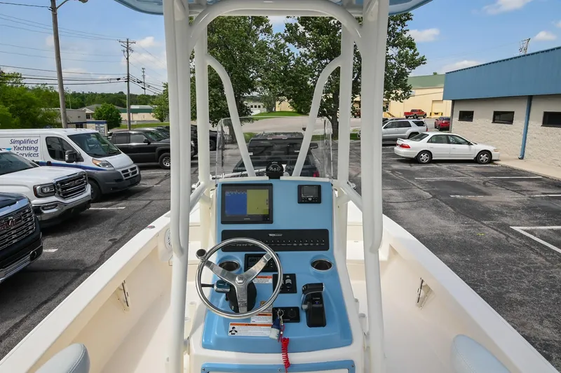 Slide: The Image of 2021 Pathfinder 2500 Hybrid boat console with steering wheel and navigation controls. - 21