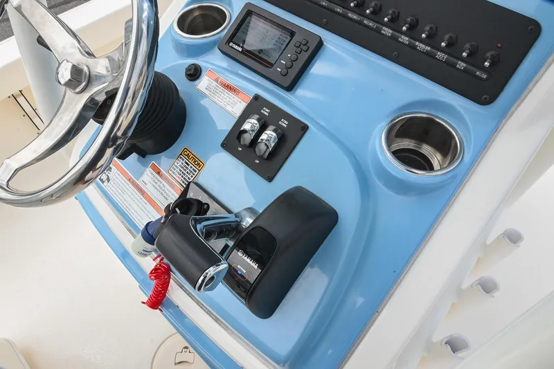 Slide: The Image of 2021 Pathfinder 2500 Hybrid boat interior with white finish, docked near a building. - 26