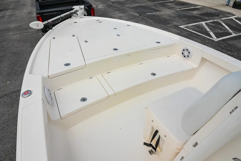 Slide: The Image of 2021 Pathfinder 2500 Hybrid boat storage compartment with open lid and speaker. - 32