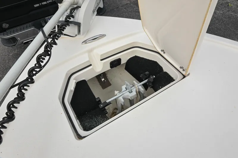 Slide: The Image of MotorGuide trolling motor on a 2021 Pathfinder 2500 Hybrid boat, parked near trucks. - 36