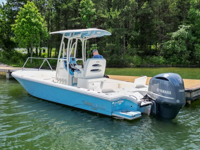 Slide: The Image of 2021 Pathfinder 2500 Hybrid boat on trailer, parked outside a building. - 38
