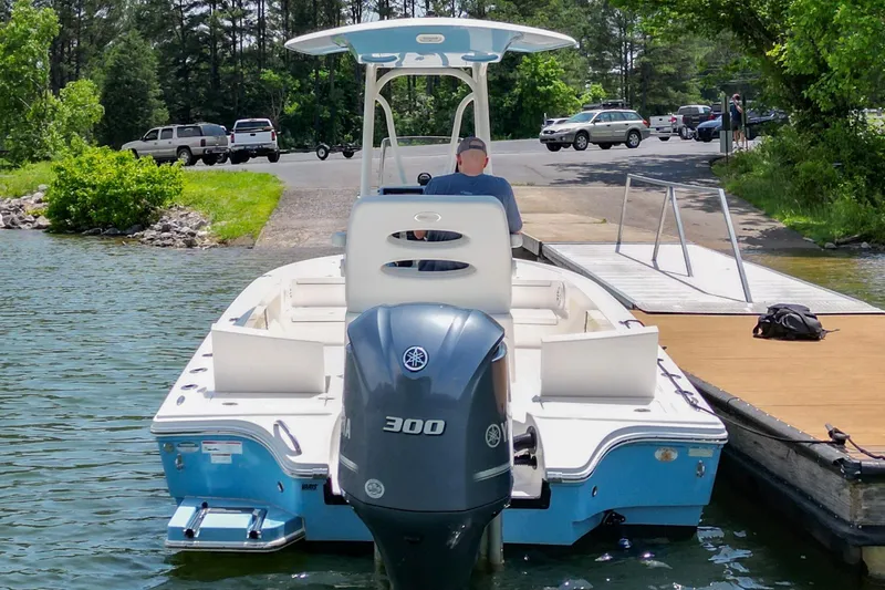 Slide: The Image of 2021 Pathfinder 2500 Hybrid boat on trailer, blue hull, parked outdoors. - 39