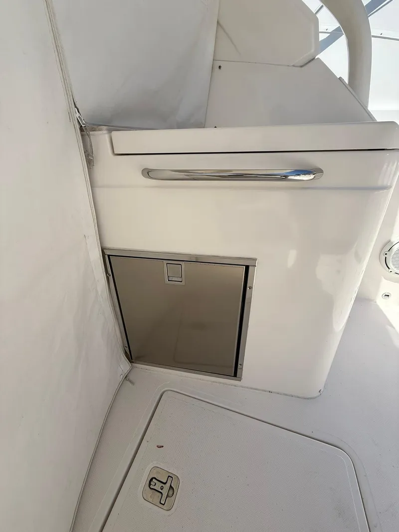 Slide: The Image of 2018 Pursuit DC 365 Dual Console interior detail with storage compartment and sleek design. - 12