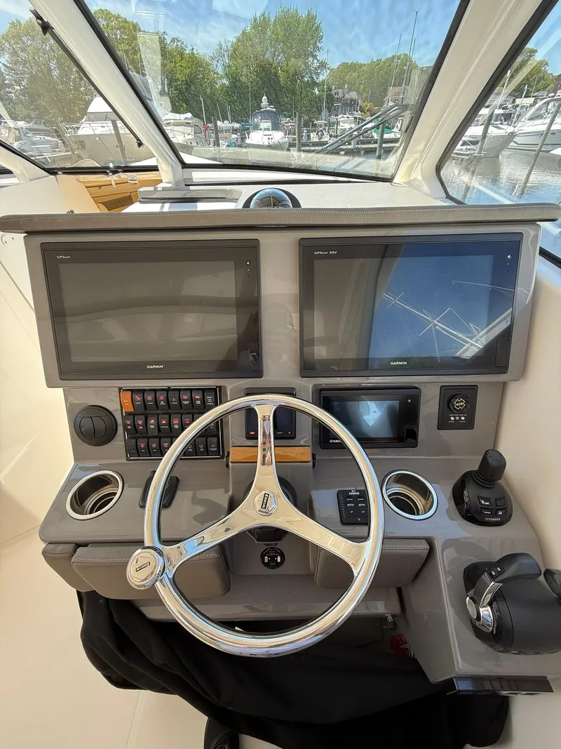 Slide: The Image of 2018 Pursuit DC 365 Dual Console helm with dual screens and steering wheel. - 16