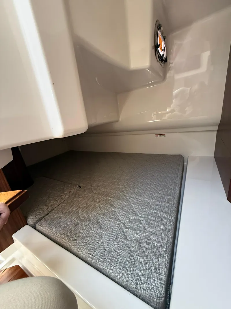 Slide: The Image of 2018 Pursuit DC 365 Dual Console cabin interior with cushioned seating. - 21