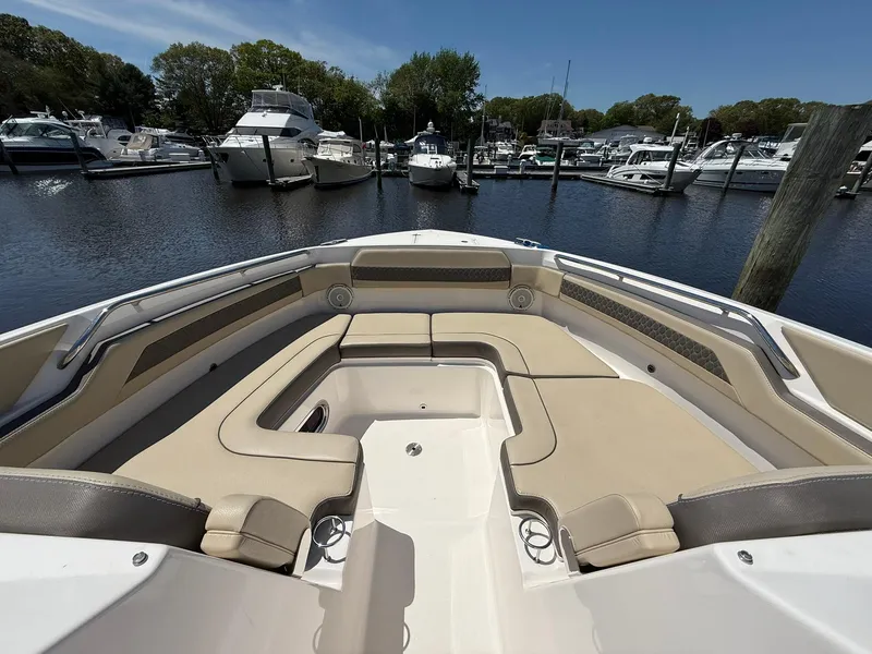 Slide: The Image of 2018 Pursuit DC 365 Dual Console boat with spacious seating at marina. - 33