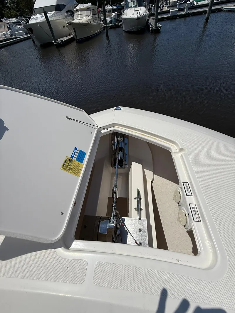 Slide: The Image of 2018 Pursuit DC 365 Dual Console anchor compartment at marina. - 37