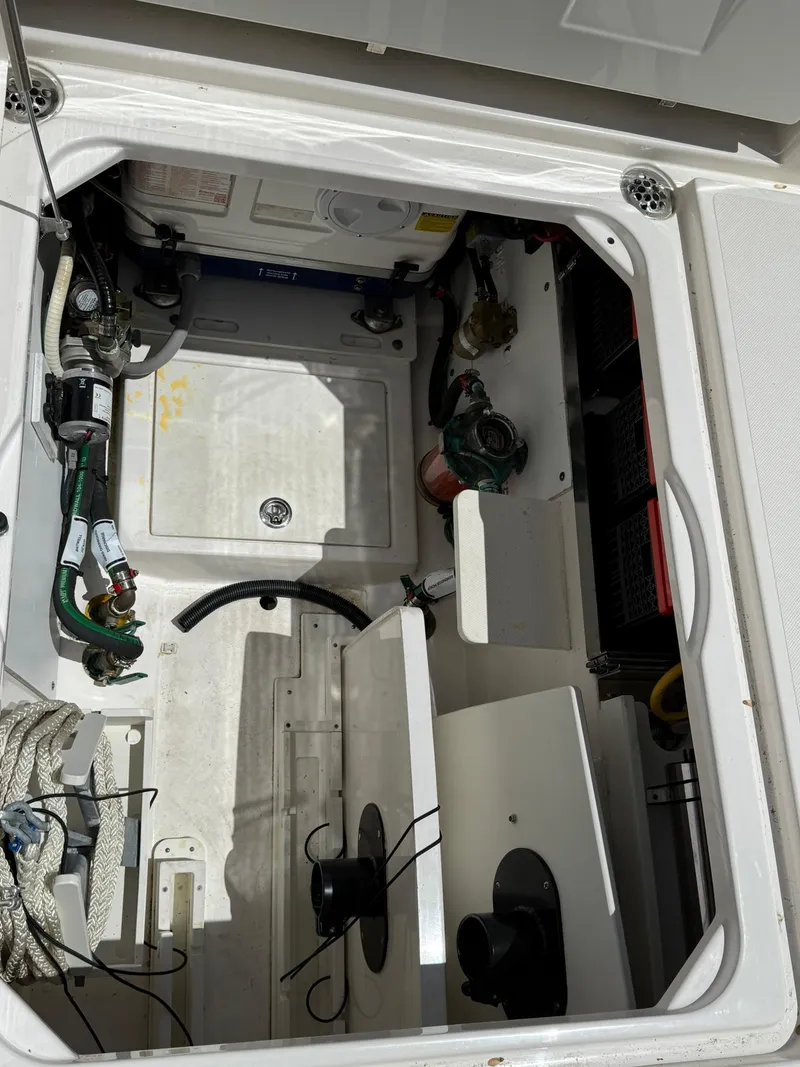 Slide: The Image of 2018 Pursuit DC 365 Dual Console storage compartment with equipment and wiring. - 4