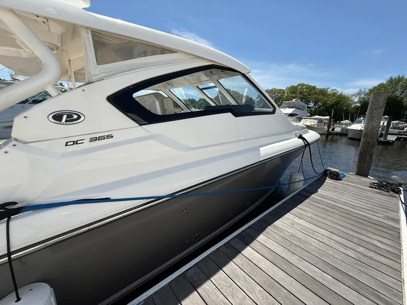 Slide: The Image of 2018 Pursuit DC 365 Dual Console boat docked at marina. - 40