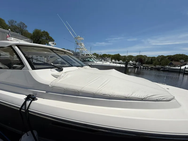 Slide: The Image of 2018 Pursuit DC 365 Dual Console boat docked at marina under clear blue sky. - 41