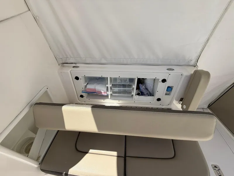 Slide: The Image of 2018 Pursuit DC 365 Dual Console interior seating and storage compartment. - 8