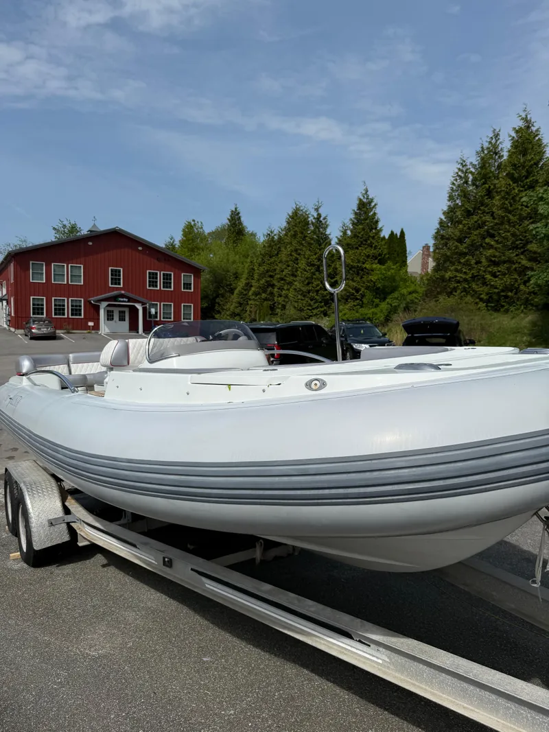 Slide: The Image of 2015 Castoldi 21 Diesel Jet Tender on trailer, parked near a red building. - 18
