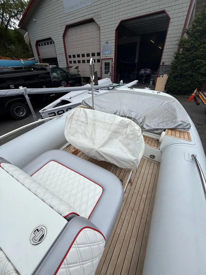 Slide: The Image of 2015 Castoldi 21 Diesel Jet Tender with white seating and wooden deck, parked near a garage. - 20