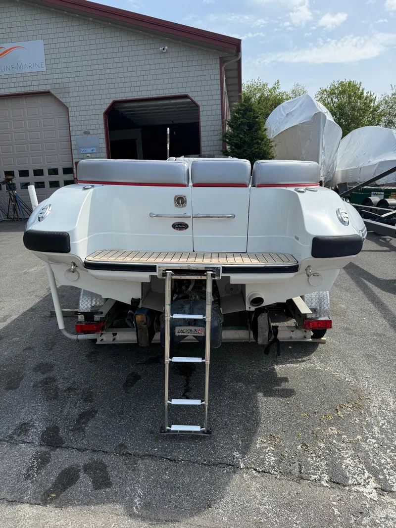 Slide: The Image of 2015 Castoldi 21 Diesel Jet Tender, rear view, parked outdoors near a garage. - 23