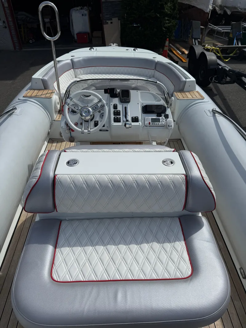 Slide: The Image of 2015 Castoldi 21 Diesel Jet Tender with luxurious white seating and modern dashboard controls. - 9