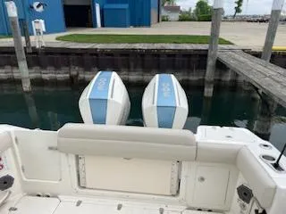 Slide: The Image of 2022 Boston Whaler 280 Outrage with twin engines docked at marina. - 13