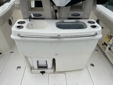 Slide: The Image of 2022 Boston Whaler 280 Outrage boat interior with sink and storage area. - 14