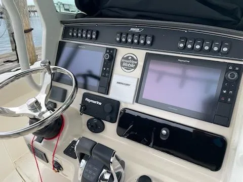 Slide: The Image of Control panel of 2022 Boston Whaler 280 Outrage with steering wheel and navigation screens. - 4