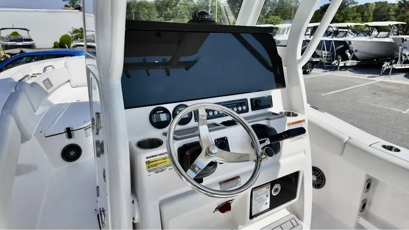 Slide: The Image of 2025 Sea Fox 248 Commander boat dashboard with steering wheel and controls. - 12
