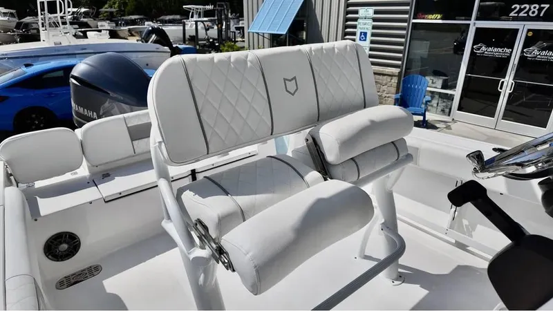Slide: The Image of 2025 Sea Fox 248 Commander boat with white cushioned seating and Yamaha engine. - 17