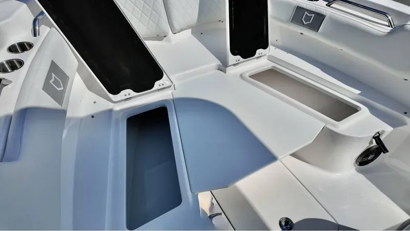 Slide: The Image of 2025 Sea Fox 248 Commander boat interior with open storage compartments and cup holders. - 18