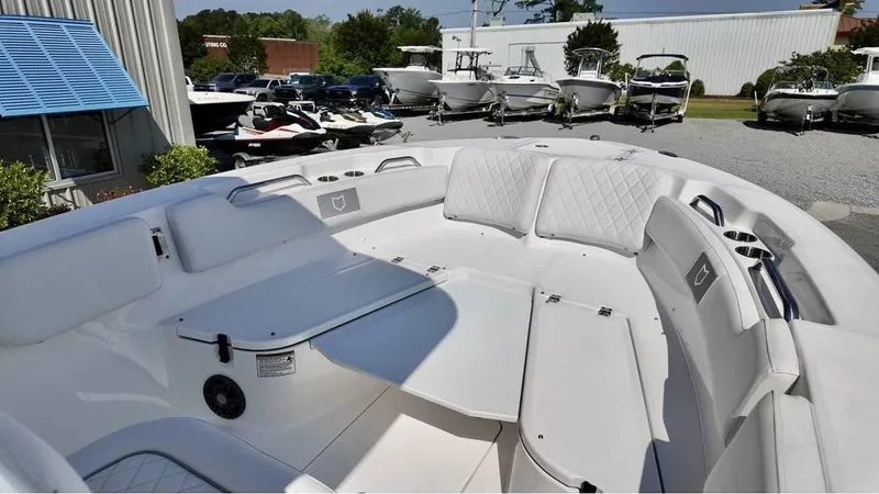 Slide: The Image of 2025 Sea Fox 248 Commander boat interior with seating and storage, displayed outdoors. - 20