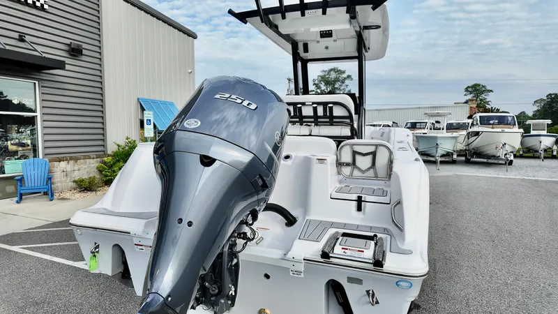 Slide: The Image of 2025 Sea Fox 248 Commander boat with powerful outboard motor, parked outdoors. - 3