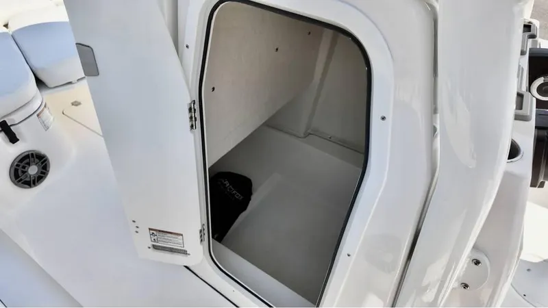 Slide: The Image of 2025 Sea Fox 248 Commander boat storage compartment, open door view. - 9