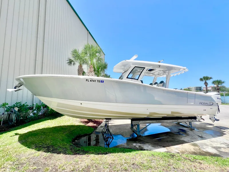 The Image of 2021 Robalo R360 Center Console boat displayed outdoors on a sunny day. - 0
