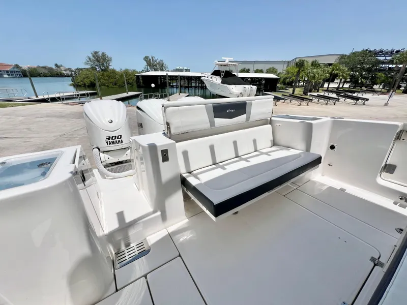 Slide: The Image of 2021 Robalo R360 Center Console boat with Yamaha 300 engine, docked near waterfront. - 10