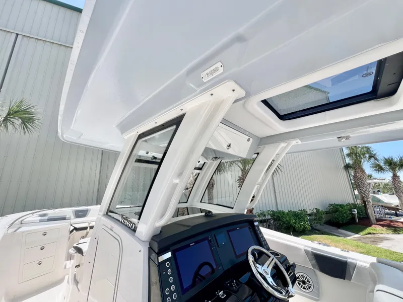 Slide: The Image of 2021 Robalo R360 Center Console boat interior with modern helm and dual screens. - 15