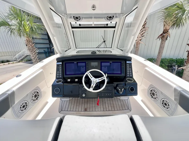Slide: The Image of 2021 Robalo R360 Center Console helm with dual screens and modern controls. - 17