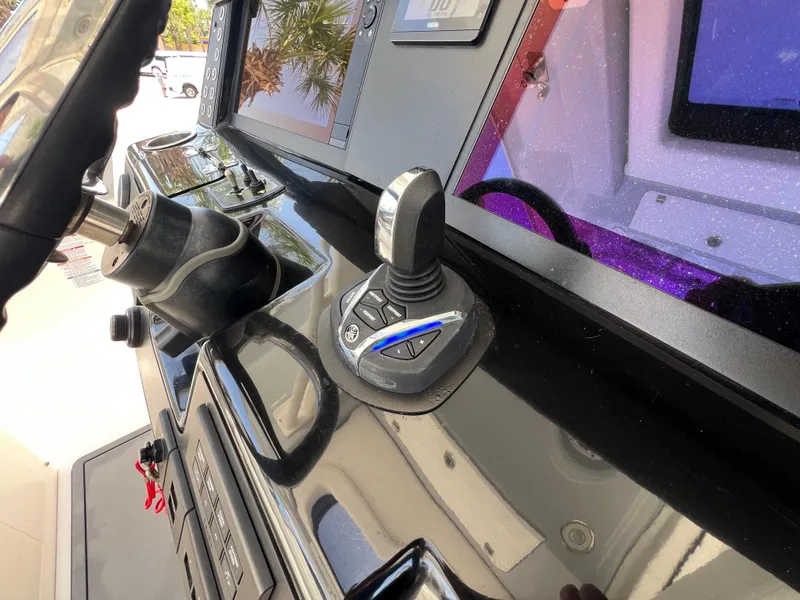 Slide: The Image of 2021 Robalo R360 Center Console dashboard with joystick control and steering wheel. - 18