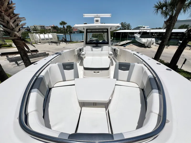 Slide: The Image of 2021 Robalo R360 Center Console boat with spacious seating and sleek design. - 25