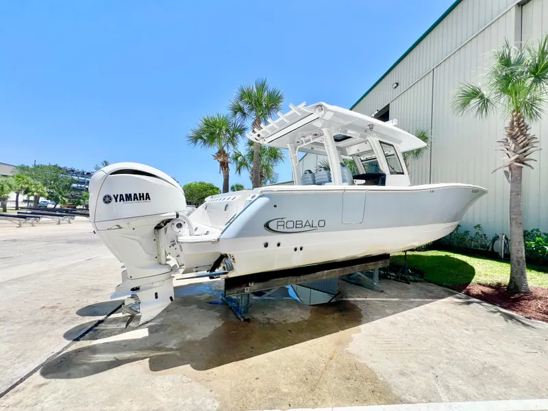 Slide: The Image of 2021 Robalo R360 Center Console boat with Yamaha engine, displayed outdoors. - 4
