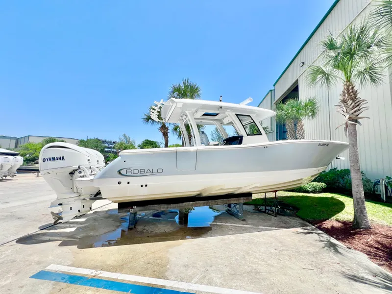 Slide: The Image of 2021 Robalo R360 Center Console boat with Yamaha engines, displayed outdoors. - 5