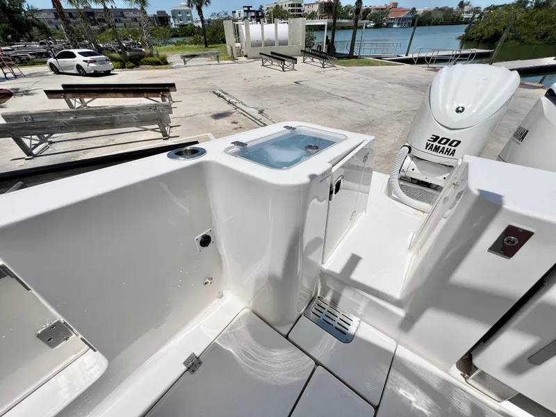 Slide: The Image of 2021 Robalo R360 Center Console boat with Yamaha 300 engine, docked near waterfront. - 6