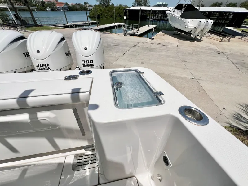 Slide: The Image of 2021 Robalo R360 Center Console with Yamaha 300 engines, docked near water. - 8